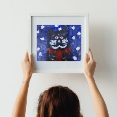 Black cat on the snow